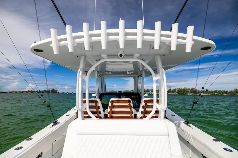  Yacht Photos Pics 2024 Costa Custom Boats 34 SV on water, showcasing fishing rod holders and seating.