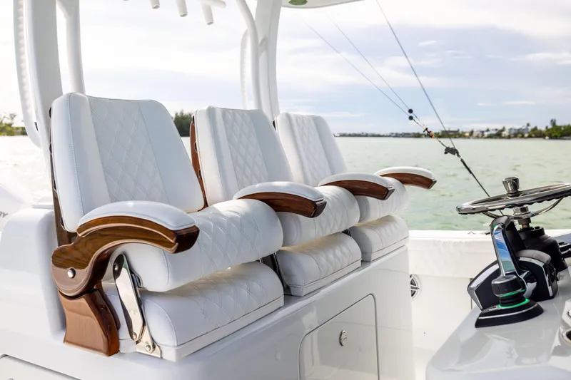  Yacht Photos Pics Luxurious seating on 2024 Costa Custom Boats 34 SV, featuring elegant white upholstery and wooden accents.