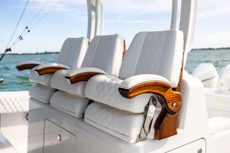  Yacht Photos Pics Luxurious seating on 2024 Costa Custom Boats 34 SV, featuring elegant wood and white upholstery.