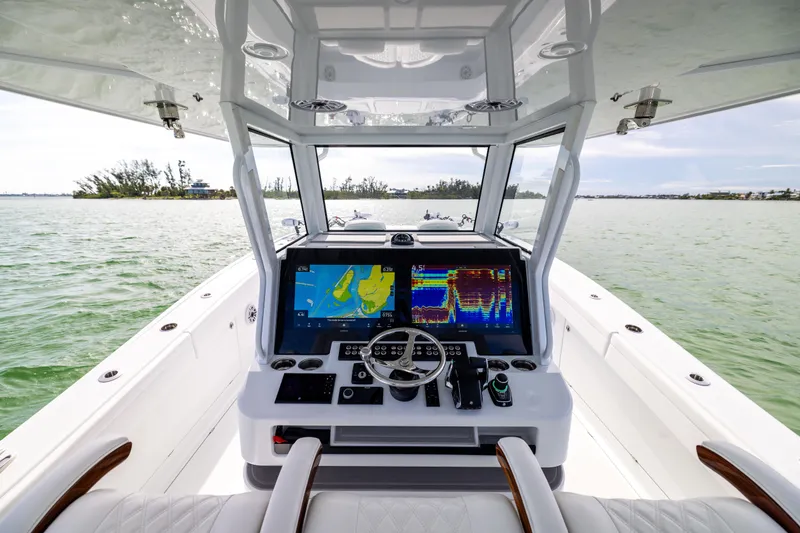  Yacht Photos Pics 2024 Costa Custom Boats 34 SV helm with advanced navigation system on open water.