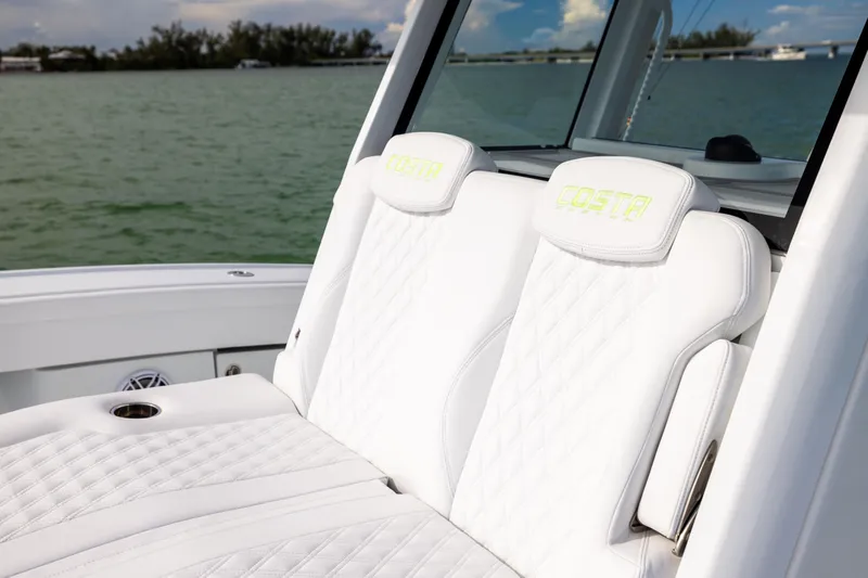  Yacht Photos Pics 2024 Costa Custom Boats 34 SV with luxurious white seating, on a serene water backdrop.