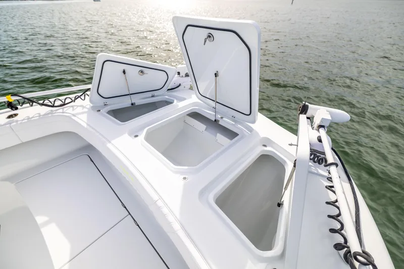  Yacht Photos Pics 2024 Costa Custom Boats 34 SV with open storage compartments on calm water.