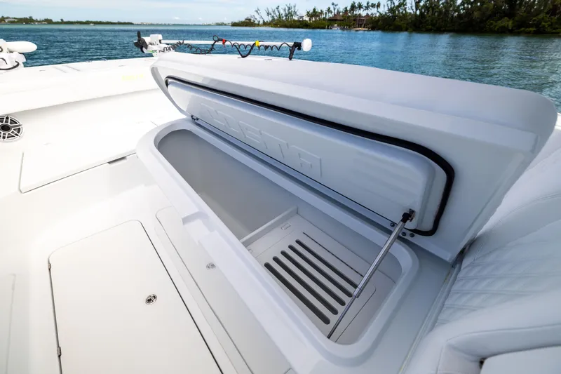  Yacht Photos Pics Open storage compartment on 2024 Costa Custom Boats 34 SV, with scenic water backdrop.