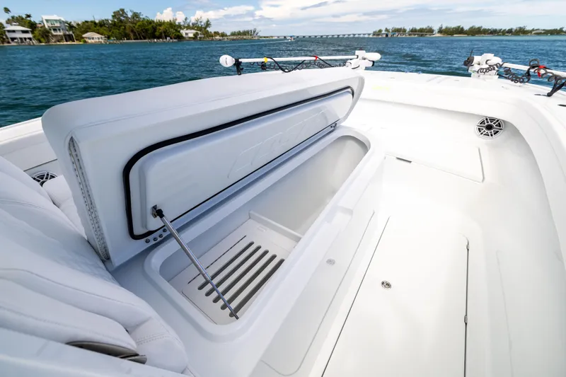 Yacht Photos Pics 2024 Costa Custom Boats 34 SV, open storage compartment, sleek white design, ocean backdrop.