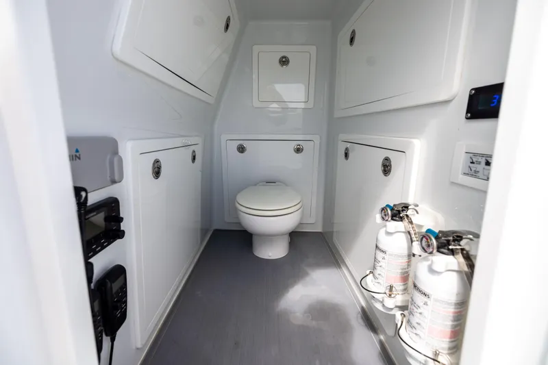  Yacht Photos Pics 2024 Costa Custom Boats 34 SV interior with toilet, storage, and safety equipment.