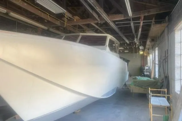  Yacht Photos Pics 2027 Compmillenia Lightspeed Tender boat in a workshop, under construction.