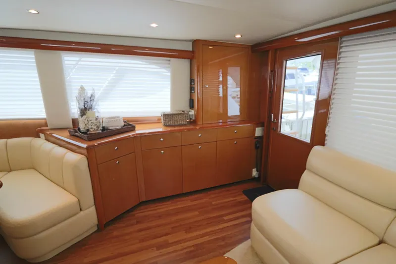 Breakaway Yacht Photos Pics Luxurious interior of a 2004 Viking 56 yacht with elegant wood finishes and cream seating.