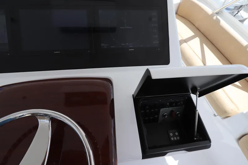 Breakaway Yacht Photos Pics Control panel of a 2004 Viking 56 yacht with steering wheel and display screens.