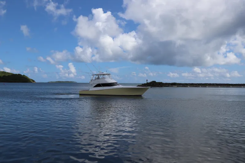 Breakaway Yacht Photos Pics 2004 Viking 56 yacht cruising on calm waters under a partly cloudy sky.