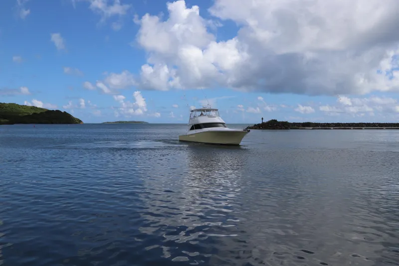 Breakaway Yacht Photos Pics 2004 Viking 56 yacht cruising on a calm, scenic ocean under a blue sky.