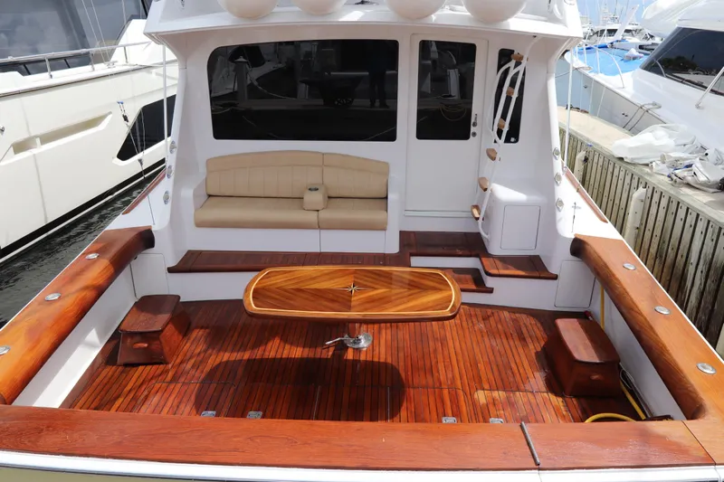 Breakaway Yacht Photos Pics 2004 Viking 56 yacht with polished wooden deck and seating area.