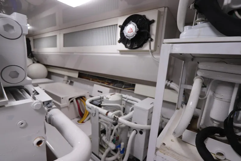 Breakaway Yacht Photos Pics Engine room of a 2004 Viking 56 yacht, showcasing mechanical components and piping.