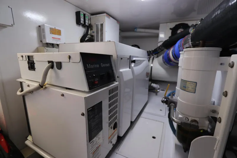 Breakaway Yacht Photos Pics Engine room of a 2004 Viking 56 yacht with marine generator and equipment.