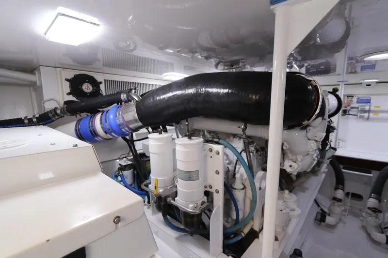 Breakaway Yacht Photos Pics Engine room of a 2004 Viking 56 yacht, featuring complex machinery and piping.