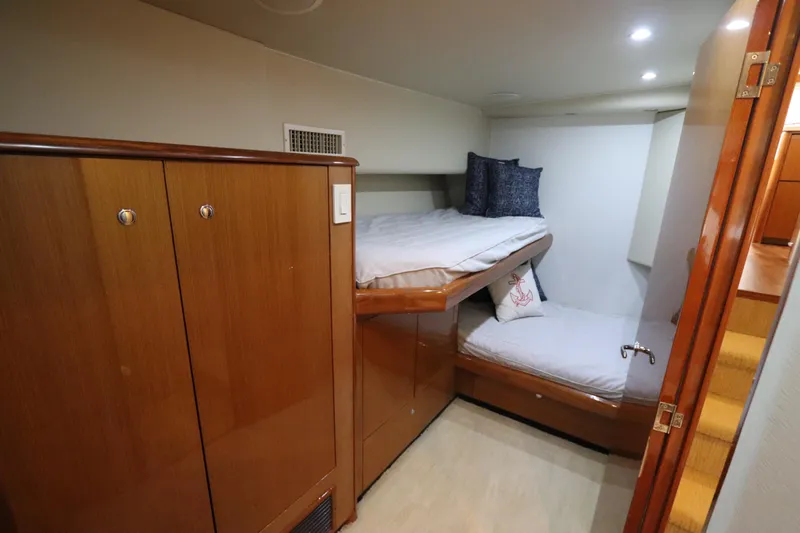 Breakaway Yacht Photos Pics Cozy cabin interior of 2004 Viking 56 yacht with wooden bunk beds and storage.