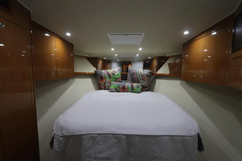 Breakaway Yacht Photos Pics Luxurious cabin interior of a 2004 Viking 56 yacht with cozy bedding and ambient lighting.