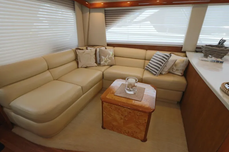 Breakaway Yacht Photos Pics Luxurious interior of 2004 Viking 56 yacht with beige leather seating and decorative pillows.