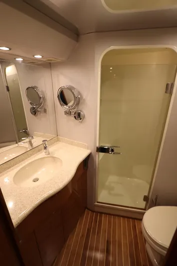 Breakaway Yacht Photos Pics Luxurious bathroom in 2004 Viking 56 yacht with modern fixtures and wooden flooring.