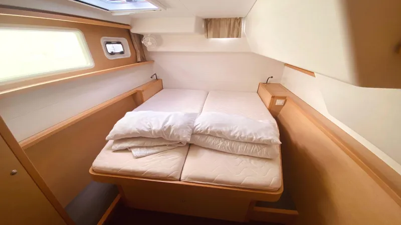  Yacht Photos Pics Cozy cabin interior of 2017 Lagoon 450 F catamaran with double bed and natural light.