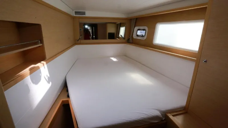 Yacht Photos Pics Interior cabin of 2017 Lagoon 450 F catamaran with bed and window.