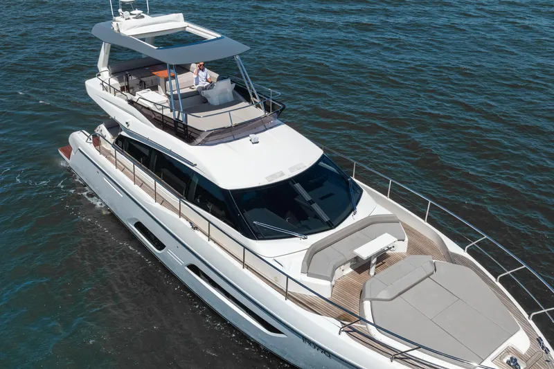 Sublime Yacht Photos Pics 2021 Ferretti Yachts 550 cruising on open water, showcasing luxury design and spacious deck.