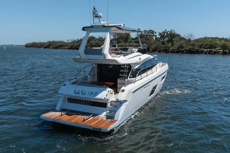 Sublime Yacht Photos Pics 2021 Ferretti Yachts 550 cruising on a serene waterway.