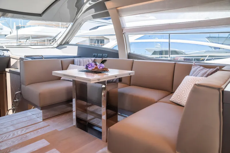 Sublime Yacht Photos Pics Luxurious interior of 2021 Ferretti Yachts 550 with elegant seating and table.