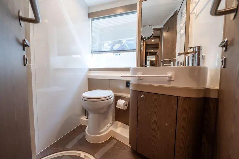 Sublime Yacht Photos Pics Luxurious bathroom in 2021 Ferretti Yachts 550, featuring modern fixtures and wood accents.