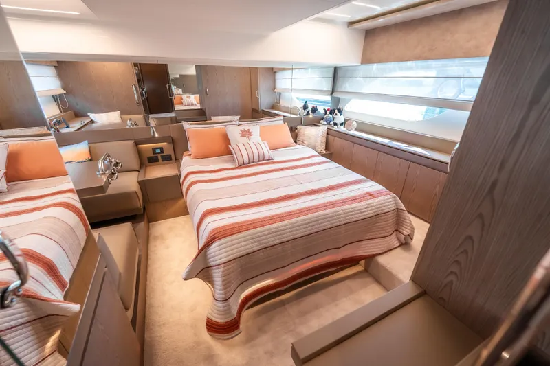 Sublime Yacht Photos Pics Luxurious bedroom interior of 2021 Ferretti Yachts 550 with striped bedding and modern decor.