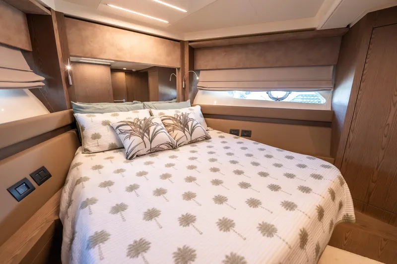 Sublime Yacht Photos Pics Luxurious bedroom interior of 2021 Ferretti Yachts 550 with elegant bedding and wood accents.