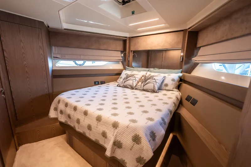 Sublime Yacht Photos Pics Luxurious bedroom interior of 2021 Ferretti Yachts 550 with elegant bedding and wood accents.