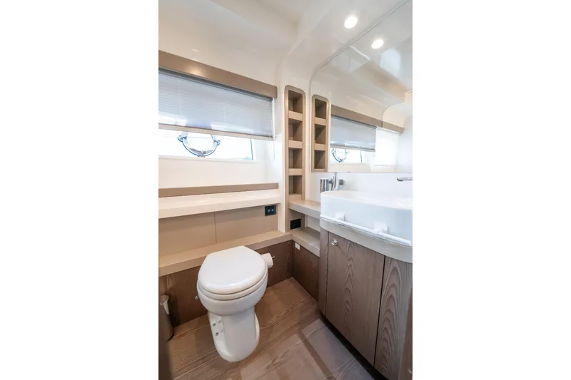 Sublime Yacht Photos Pics Luxurious bathroom interior of 2021 Ferretti Yachts 550 with modern fixtures and wood accents.