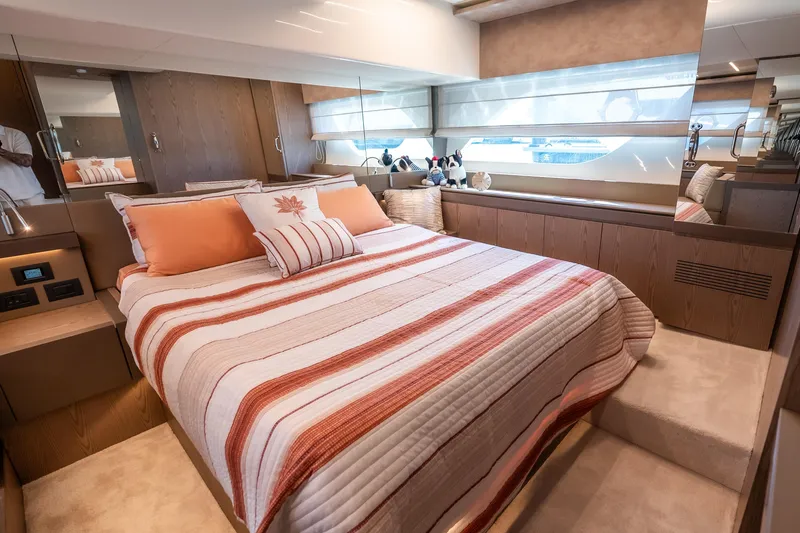 Sublime Yacht Photos Pics Luxurious bedroom interior of 2021 Ferretti Yachts 550 with striped bedding and modern design.