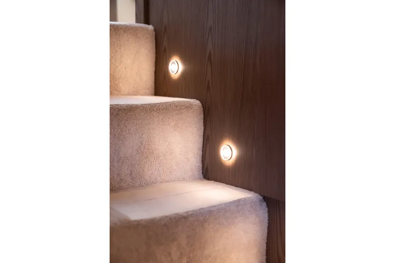 Sublime Yacht Photos Pics Carpeted stairs with wall lights on a 2021 Ferretti Yachts 550.