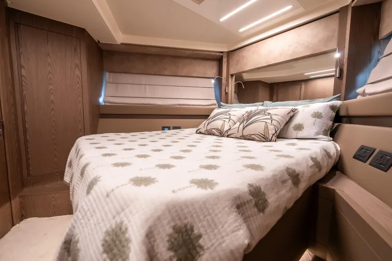 Sublime Yacht Photos Pics Luxurious bedroom interior of 2021 Ferretti Yachts 550 with elegant bedding and wood accents.