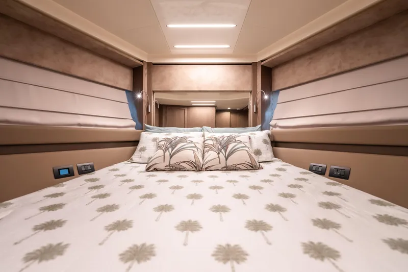 Sublime Yacht Photos Pics Luxurious bedroom interior of 2021 Ferretti Yachts 550 with elegant bedding and ambient lighting.
