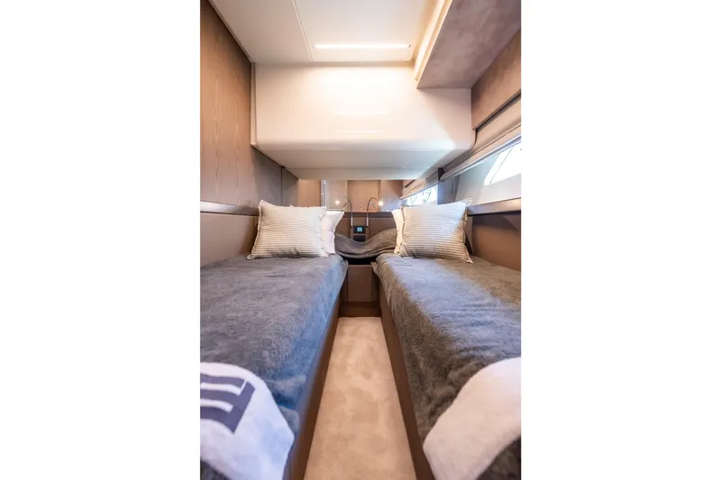 Sublime Yacht Photos Pics Luxurious twin cabin interior of 2021 Ferretti Yachts 550, featuring elegant bedding and modern design.