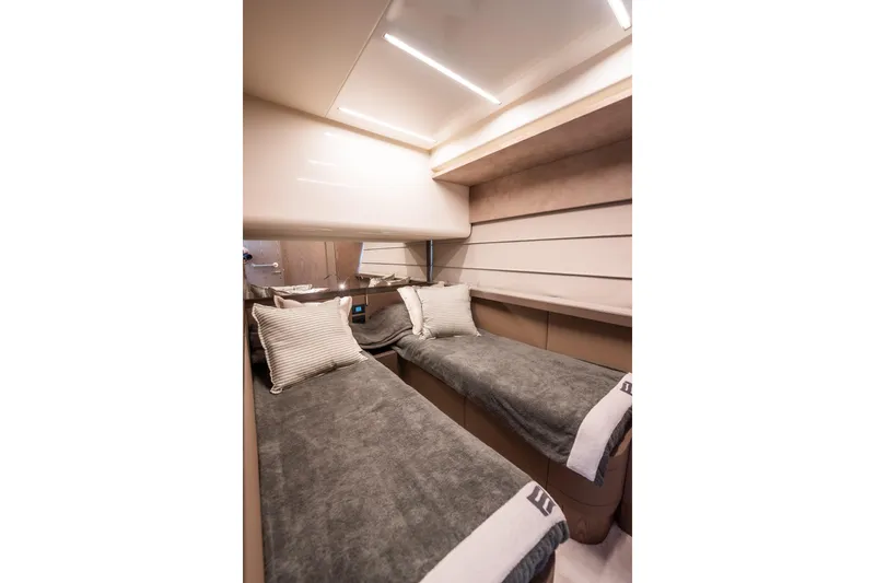 Sublime Yacht Photos Pics Luxurious twin cabin interior of 2021 Ferretti Yachts 550, featuring modern design and cozy bedding.