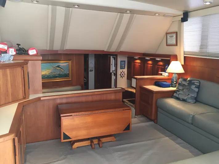  Yacht Photos Pics Interior of 1989 Viking 41 Sportfish Convertible with wooden furniture and cozy lighting.