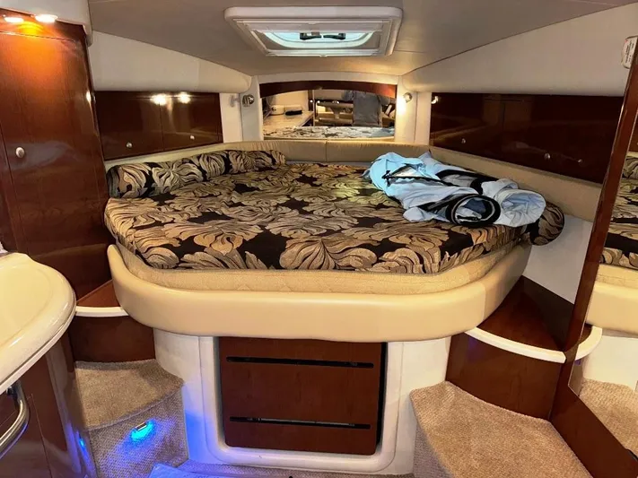  Yacht Photos Pics 2008 Sea Ray 340 Sundancer cabin with floral bedding and wood accents.