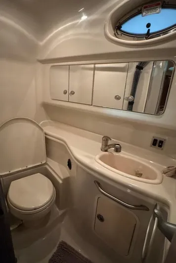  Yacht Photos Pics 2008 Sea Ray 340 Sundancer bathroom with sink, toilet, and mirrored cabinet.