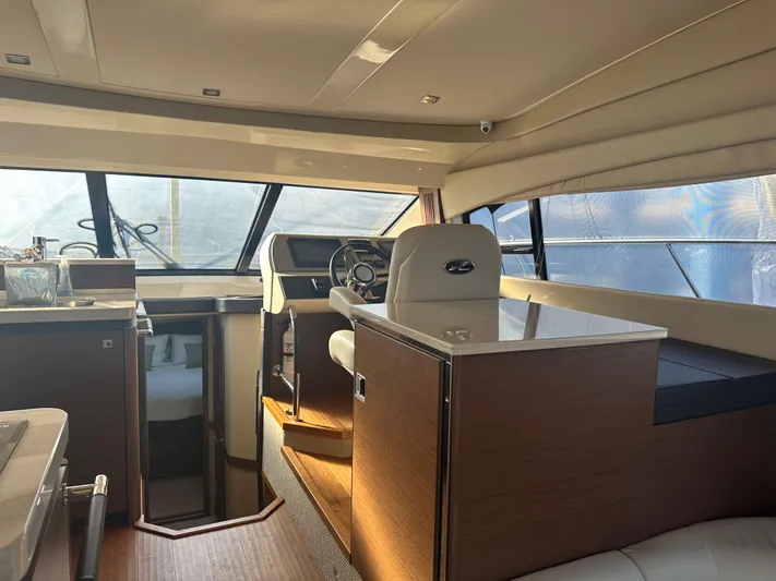  Yacht Photos Pics Interior of 2015 Sea Ray 510 Fly yacht, featuring modern helm and seating area.