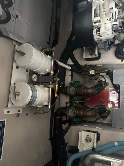  Yacht Photos Pics Engine room of 2015 Sea Ray 510 Fly, showcasing mechanical components and filters.