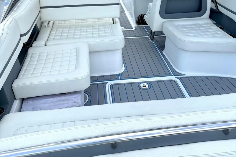 Drama Free Yacht Photos Pics 2022 Cobalt R30 boat interior with white cushioned seating and sleek flooring design.