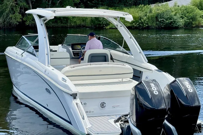 Drama Free Yacht Photos Pics 2022 Cobalt R30 boat with dual Mercury engines on a serene lake.