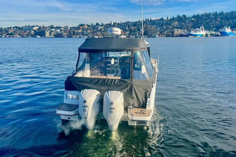  Yacht Photos Pics 2024 Jeanneau NC 1095 Coupe Series 2 boat on calm water with twin Yamaha engines.