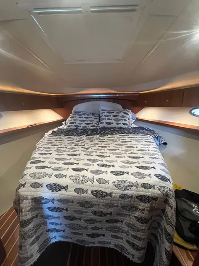 Papa Joe Yacht Photos Pics Cozy cabin interior of 2006 Tiara Yachts 3600 Open with fish-patterned bedding.