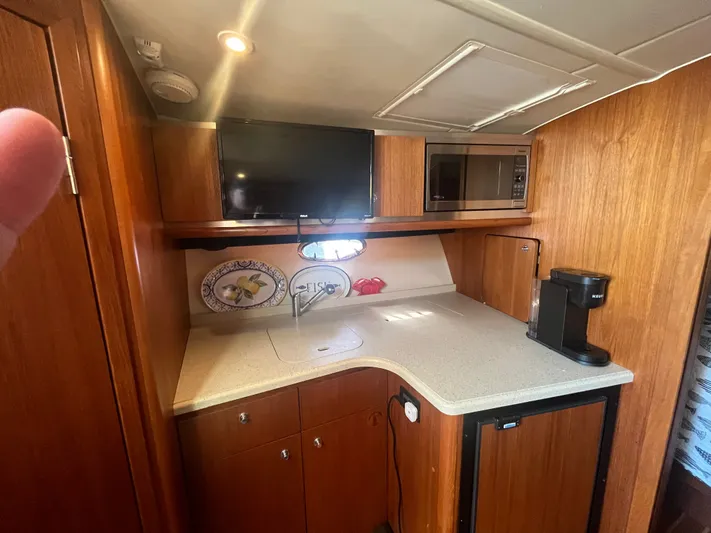 Papa Joe Yacht Photos Pics 2006 Tiara Yachts 3600 Open galley with wood cabinetry, TV, microwave, and coffee maker.