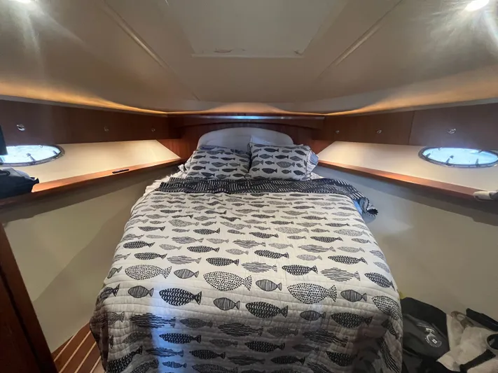 Papa Joe Yacht Photos Pics Cozy cabin interior of 2006 Tiara Yachts 3600 Open with fish-patterned bedding.