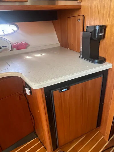 Papa Joe Yacht Photos Pics 2006 Tiara Yachts 3600 Open galley with countertop, Keurig coffee maker, and wooden cabinetry.